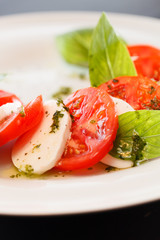 Tomato and mozzarella with basil leaves
