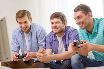 smiling friends playing video games at home