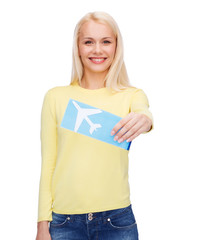 smiling young woman with airplane ticket