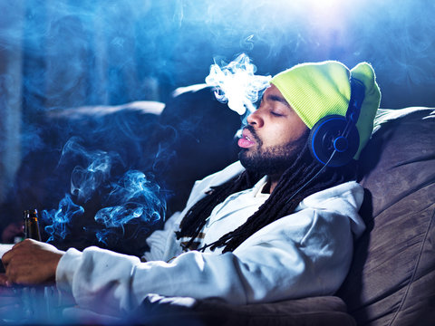 smoking marijuana and drinking beer amid clouds of smoke