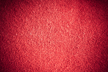 Red textured leather skin grunge background closeup