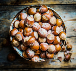 Hazelnuts on rustic wooden background