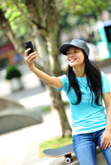    skateboarding woman use her cellphone at  skateboard park