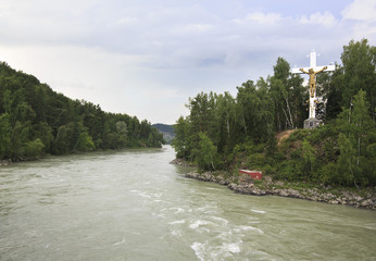 Cross with crucifix on the island of the Katun River.