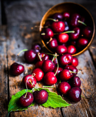 Cherries on rustic wooden background