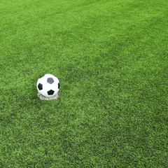 Fototapeta na wymiar view of green striped football field with soccer ball 