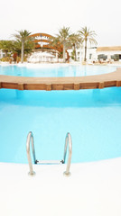 Fototapeta na wymiar railing stairs down to the pool with fresh water