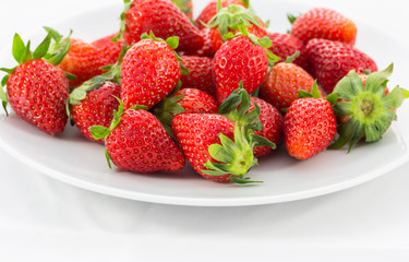 Fresh strawberry isolated on white plate.