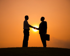 Silhouette of Two Businessmen Having a Handshake