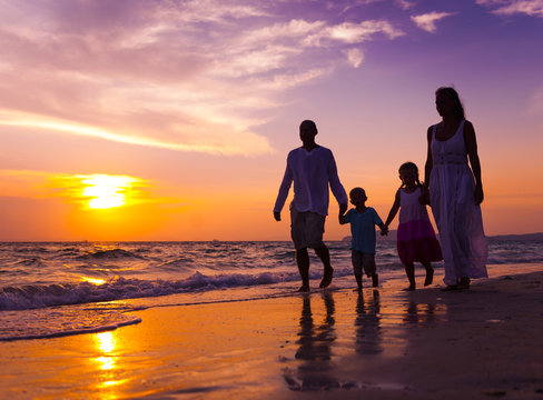 Family Walking On The Beach