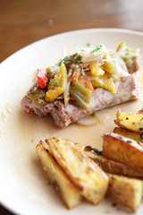 Sausage with potato on wood background