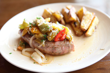 Sausage with potato on wood background