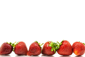 Red strawberries in a row over white