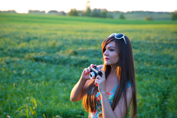 Girl with camera on the field