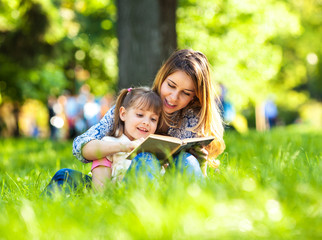 Mother and daughter relaxing in park.