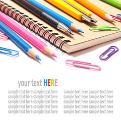 notebook and color pencils stationery isolated on white backgrou