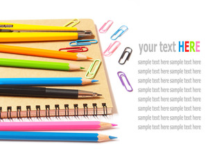 Fototapeta premium notebook and color pencils stationery isolated on white backgrou