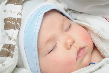 Fototapeta na wymiar Newborn baby sleeping in clothes