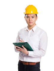 Asian engineer holding clipboard