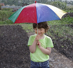 Laughing boy under an umbrella