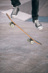 Legs in sneakers on a skateboard