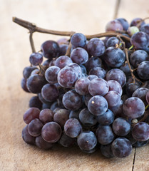 Grapes on a old wooden table.