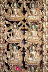 Fototapeta premium Buddha and disciples carved wood of temple gate.