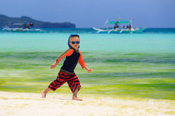 little boy playing on the beach