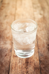 Cool water drink in glass on wooden