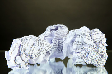 Crumpled paper balls on table on gray background