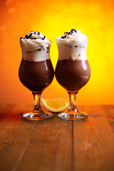Tasty dessert with chocolate, cream and orange sauce,