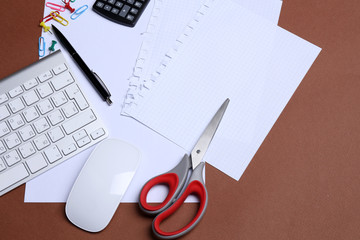 Office table with stationery accessories, keyboard and paper,