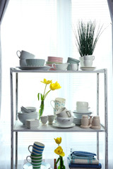 Different tableware on shelf in the interior