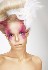 Showy Woman with Fuzzy Feathers and Fantastic Art Makeup