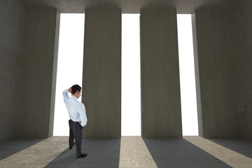 Fototapeta premium Composite image of thinking businessman scratching head