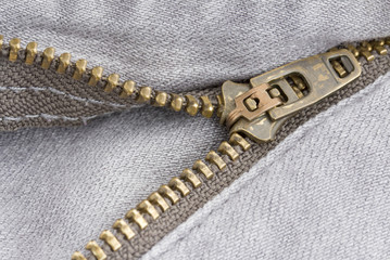 Close up zipper on a pair of grey jeans