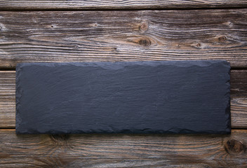 Rustikaler Holz Hintergrund mit Schiefertafel in Schwarz