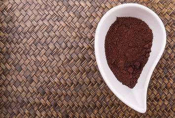 Ground coffee powder in ceramic container 