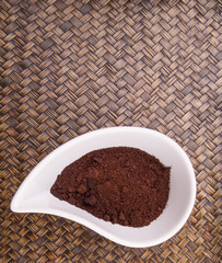 Ground coffee powder in ceramic container 