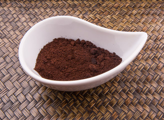 Ground coffee powder in ceramic container 