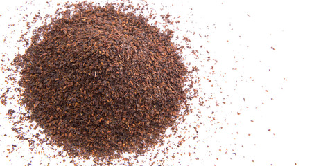 Dried tea leaves over white background