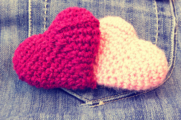 knitted valentine's hearts on a vintage jeans background