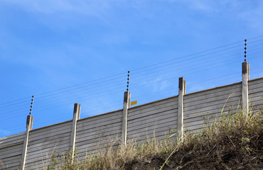 Electric Security Fence Atop a Precast Wall