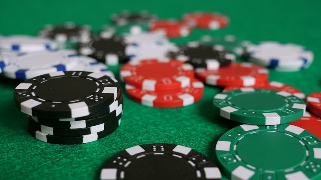 Falling Poker Chips on a Game Table (Slow Pan)