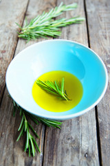 fresh rosemary bunch in bowl with olive oil