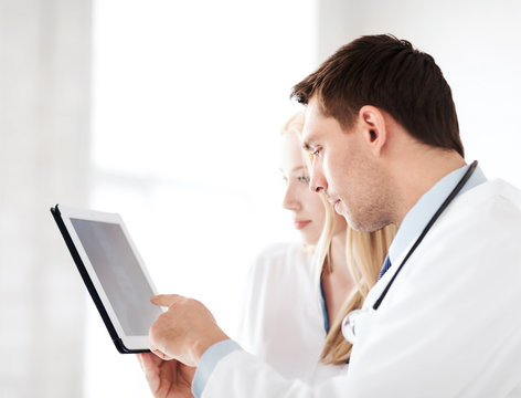 two doctors looking at x-ray on tablet pc