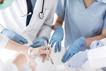young group of doctors doing operation