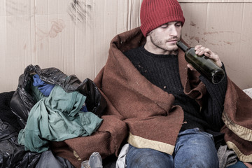Homeless drinking cheap wine