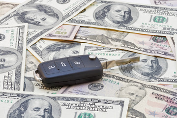 Car keys over dollar banknotes