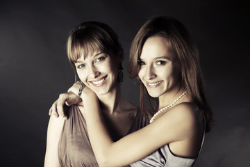 Two happy young fashion women